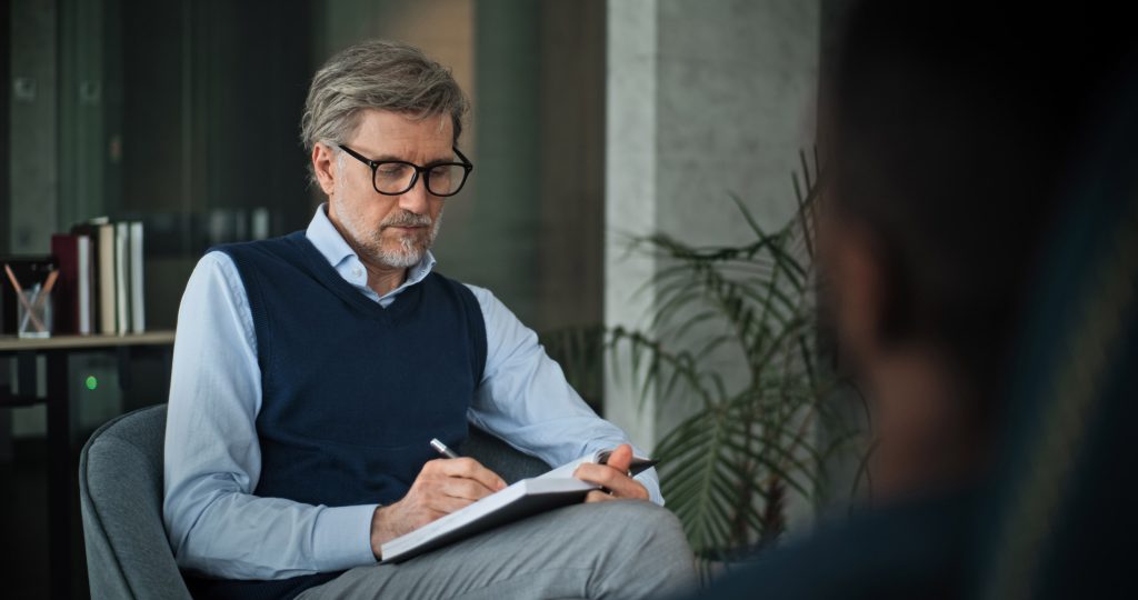 Clinician reviewing patient records in an office